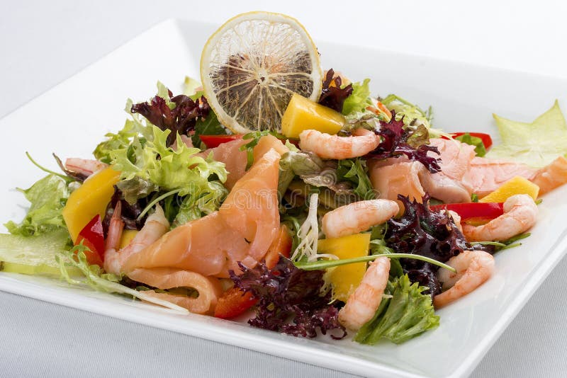 Salad with salmon and shrimp. On white background