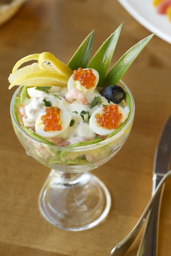 Salad with shrimps, avocado, pineapple, quail eggs