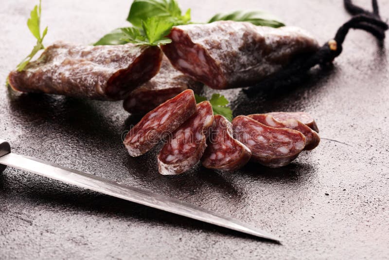 Salami Cut. Thinly Sliced Salami on a Wooden Texture on the Background