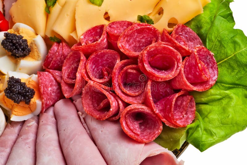 Salami rolls on dish, closeup.