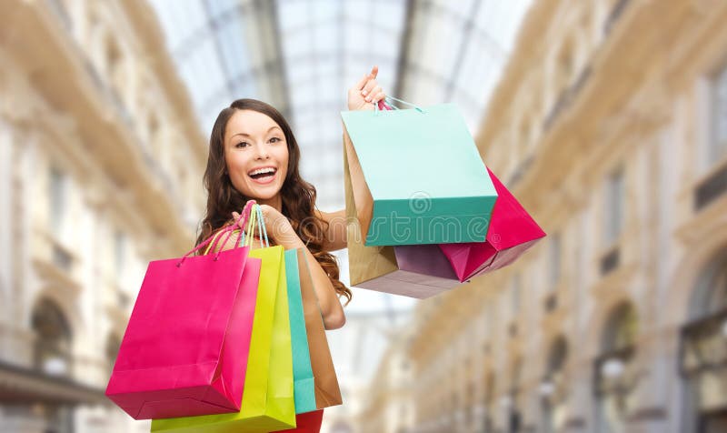Woman with shopping bags over mall background royalty free stock images Woman with shopping bags over mall background royalty free stock images