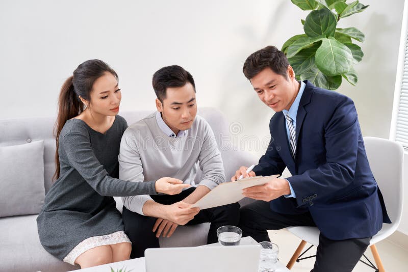 Sales Consultant Showing New Investment Plans To Young Asian Couple Stock Image - Image of talking, lawyer: 154944803