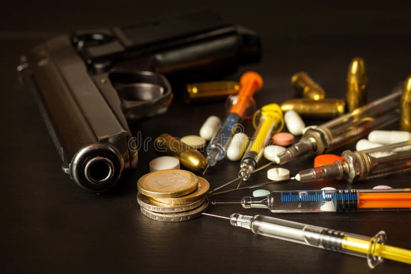 Sales of narcotics. Weapon and drugs on the table. Handgun and ammunition.