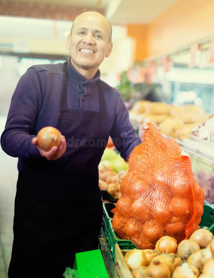 Salesman offering large onion royalty free stock image Salesman offering large onion royalty free stock image