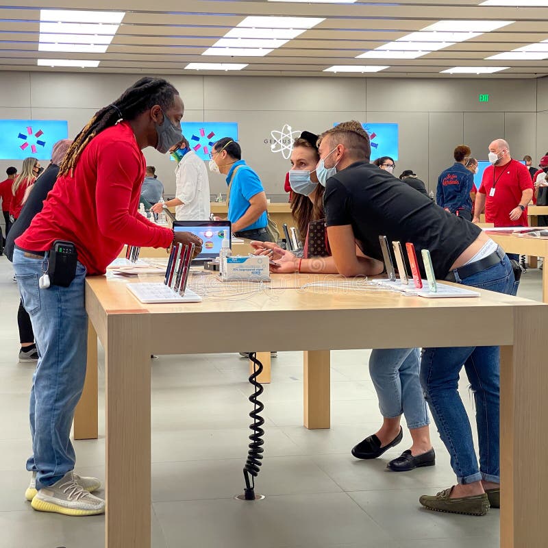 A Salesperson and Customers at an Apple Store Looking at the Latest Apple  IPhone 12 Models for Sale Editorial Stock Photo - Image of consumerism,  design: 203627358