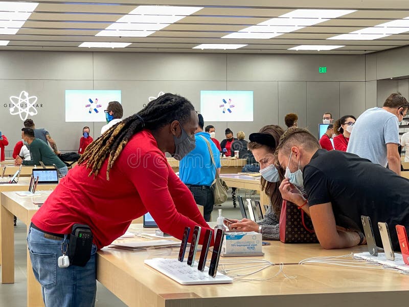 A Salesperson and Customers at an Apple Store Looking at the Latest Apple  IPhone 12 Models for Sale Editorial Stock Photo - Image of consumerism,  design: 203627358