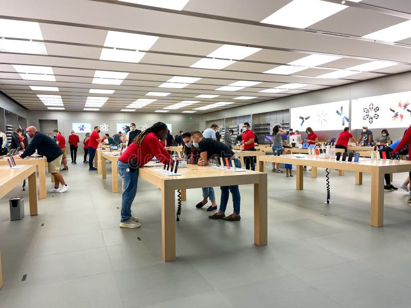 A Salesperson and Customers at an Apple Store Looking at the Latest Apple  IPhone 12 Models for Sale Editorial Stock Photo - Image of consumerism,  design: 203627358