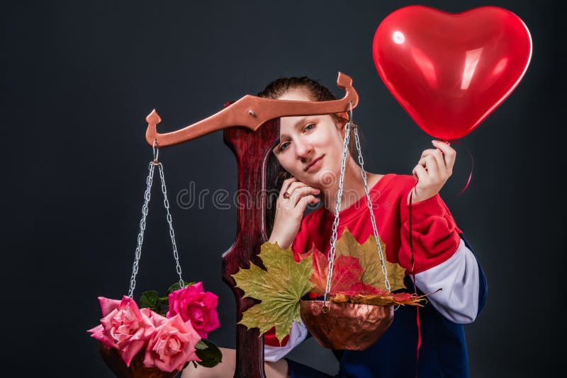 Saleswoman of beautiful autumn mood with colorful maple leaves, flowers and a heart shaped balloon royalty free stock photos Saleswoman of beautiful autumn mood with colorful maple leaves, flowers and a heart shaped balloon royalty free stock photos