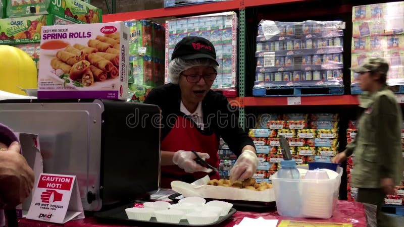 Saleswoman offering spring roll food samples to customers