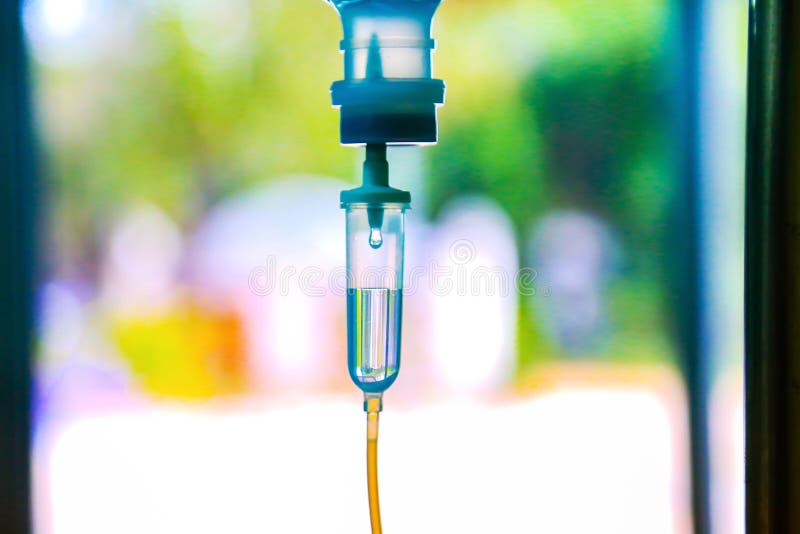 Saline iv drip fluid intravenous drop hospital room,medical concept,treatment emergency and injection drug infusion care therapy chemotherapy, flare light background. Saline iv drip fluid intravenous drop hospital room,medical concept,treatment emergency and injection drug infusion care therapy chemotherapy, flare light background