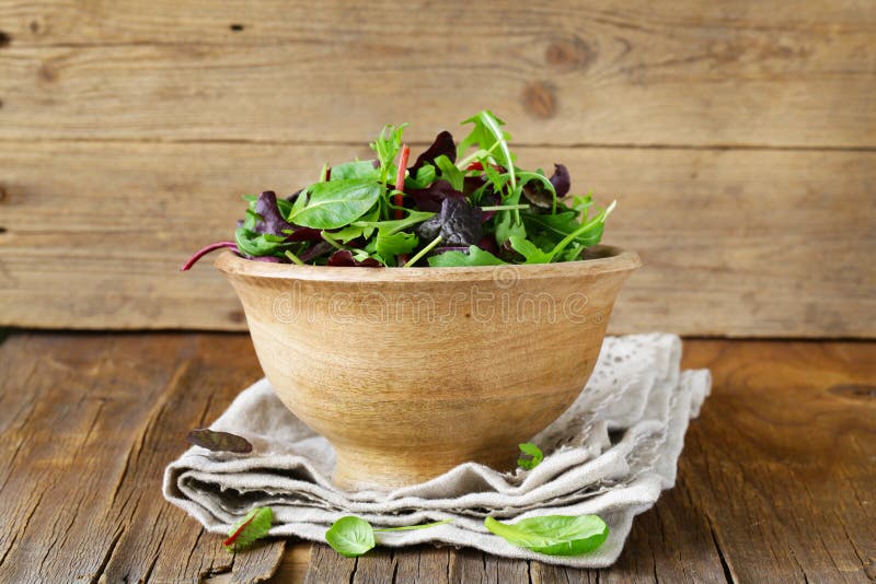 Mix salad (arugula, iceberg, red beet) in a wooden bowl. Mix salad (arugula, iceberg, red beet) in a wooden bowl