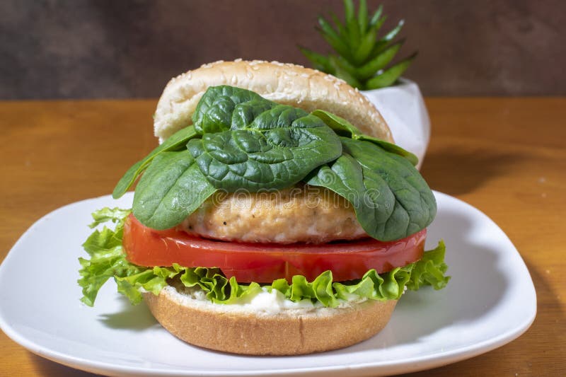 Salmon Burger Top with Spinach on a Sesame Bun Stock Photo Image of