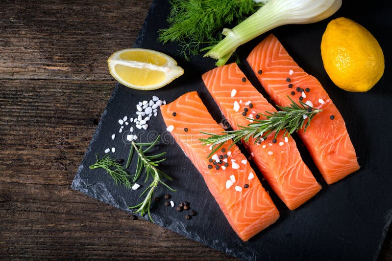 Salmon filet sliced on three parts with lime.