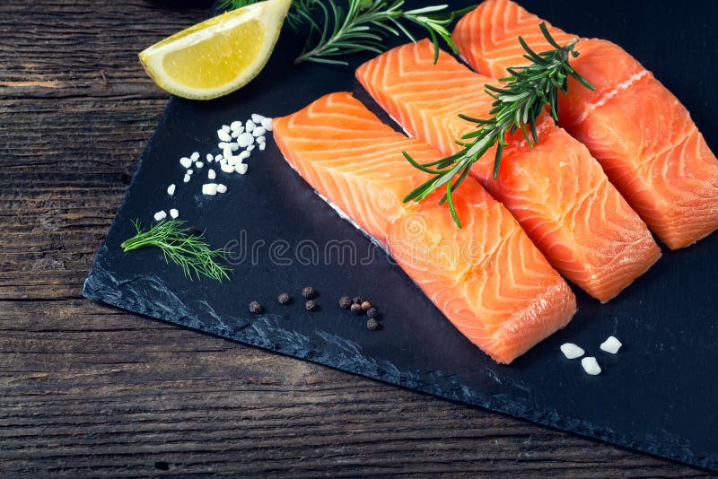 Salmon filet sliced on three parts with lime.