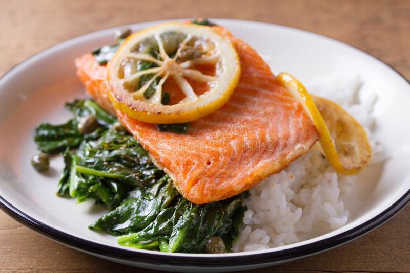 Salmon Fillet with Rice, Spinach and Lemon. Salmon with Garnish. Fish