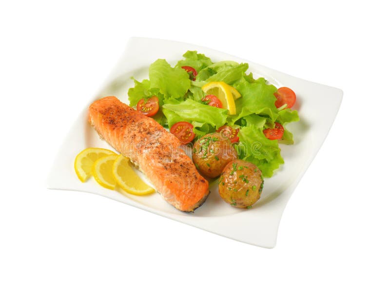 Salmon Fillet with Roasted Potatoes and Fresh Vegetables Stock Photo
