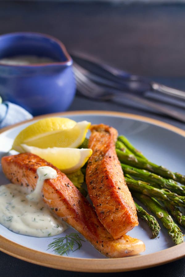 Salmon Fish Fillet with Asparagus and Creamy Garlic Sauce. Stock Image ...
