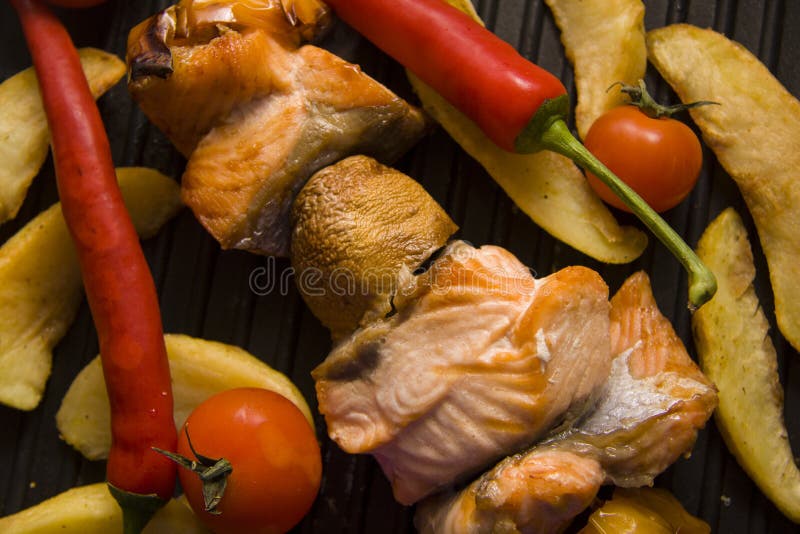 Salmon kebab and potato on grill