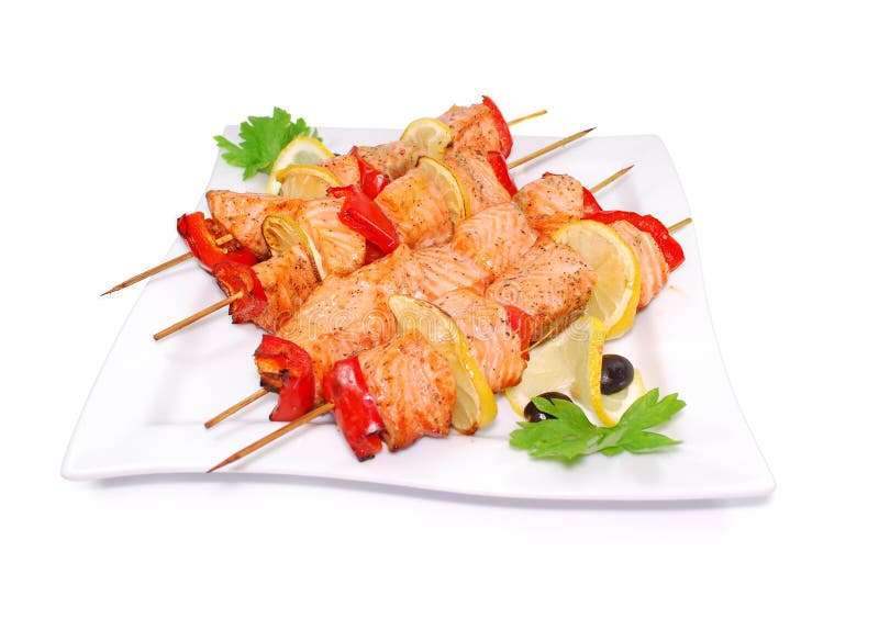 Salmon kebab. Shashlik with roasted fish, tomatoes and lemon on a white background. Roasted skewer grill stock images, royalty-free photos and pictures