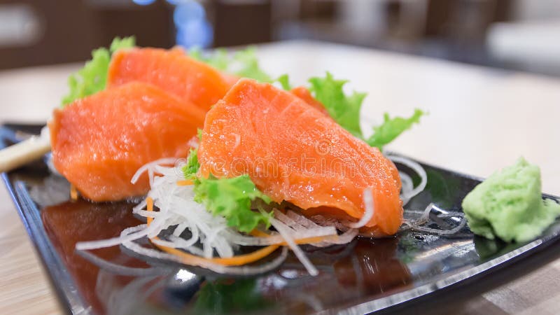 Salmon sashimi on a dish with vegetables royalty free stock image Salmon sashimi on a dish with vegetables royalty free stock image