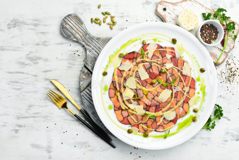 Salmon and Tuna Carpaccio with Sauce and Cheese on a White Plate. Stock Image Image of