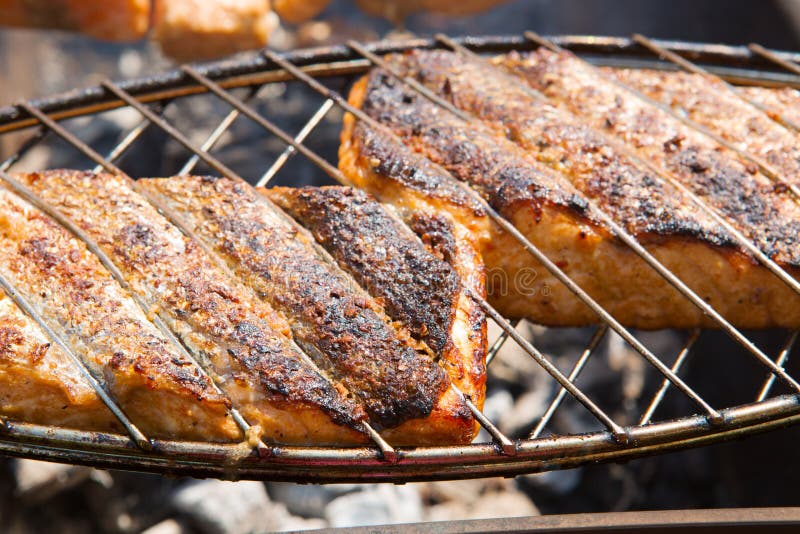 Grilled salmon steaks on the grill.Two fresh crispy grilled salmon. Grilled salmon steaks on the grill.Two fresh crispy grilled salmon.