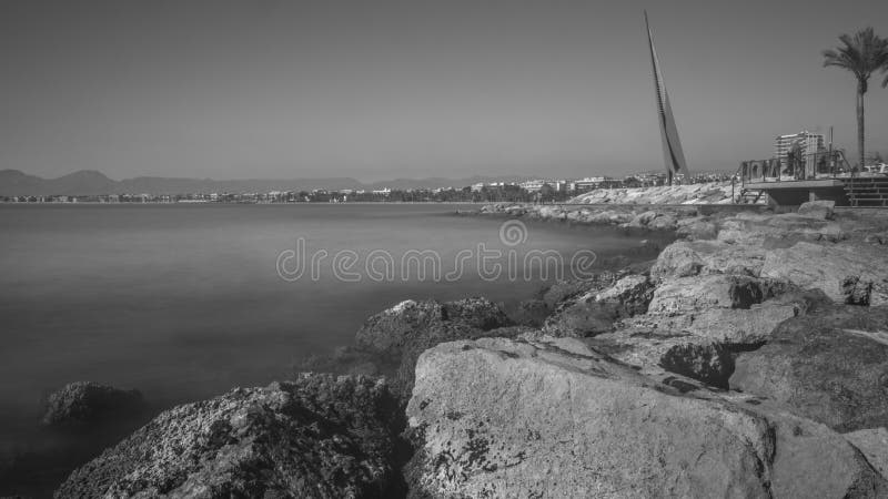 Salou´s main beach called `Playa del Llevant`. Tarragona. Spain Big welcome sign `Salou` on top of the promenade. Smooth water surface of the Mediterranean sea. Rocks breakwater line next to the promenade Clear skys on the horizon This picture was taken at the end of february. Salou´s main beach called `Playa del Llevant`. Tarragona. Spain Big welcome sign `Salou` on top of the promenade. Smooth water surface of the Mediterranean sea. Rocks breakwater line next to the promenade Clear skys on the horizon This picture was taken at the end of february