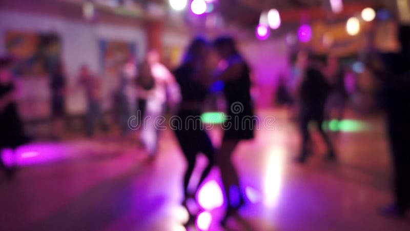 Salsa dancing in a latin dance club, blurry