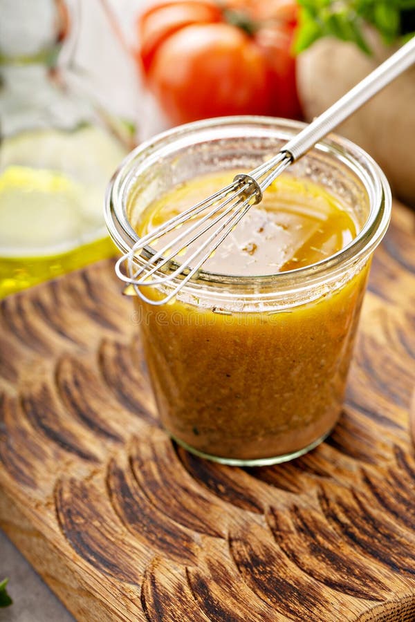 Homemade greek salad dressing or marinade in a glass jar. Homemade greek salad dressing or marinade in a glass jar