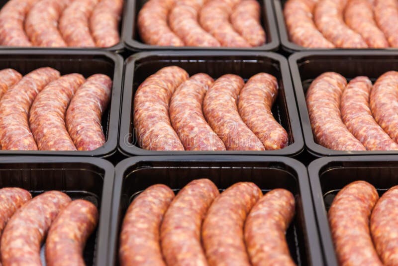 Raw meat sausages in packing box, meat production. Raw meat sausages in packing box, meat production