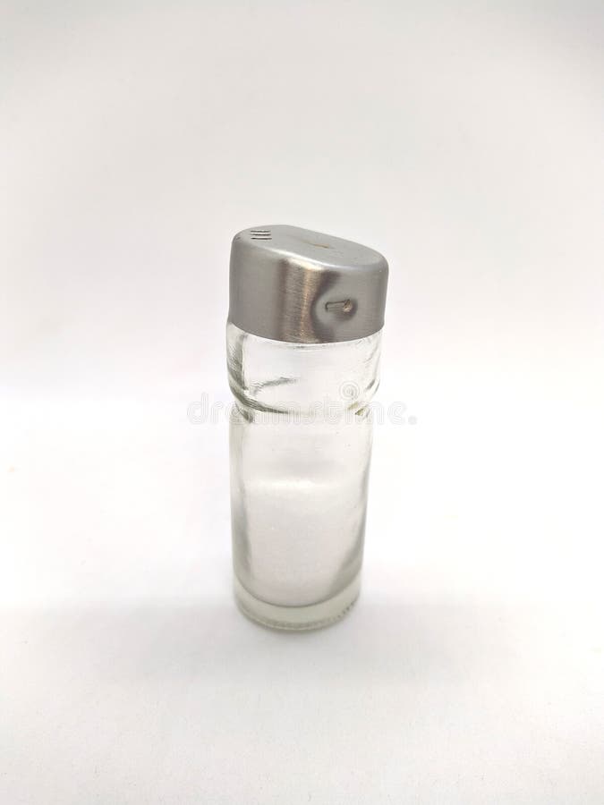 Salt in a Glass Salt Shaker on a White Background. Stock Photo Image