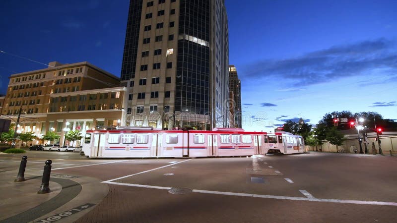 SALT LAKE CITY - JULY 14, 2019: City tram speeds up along Downtown Streets on a beautiful summer night