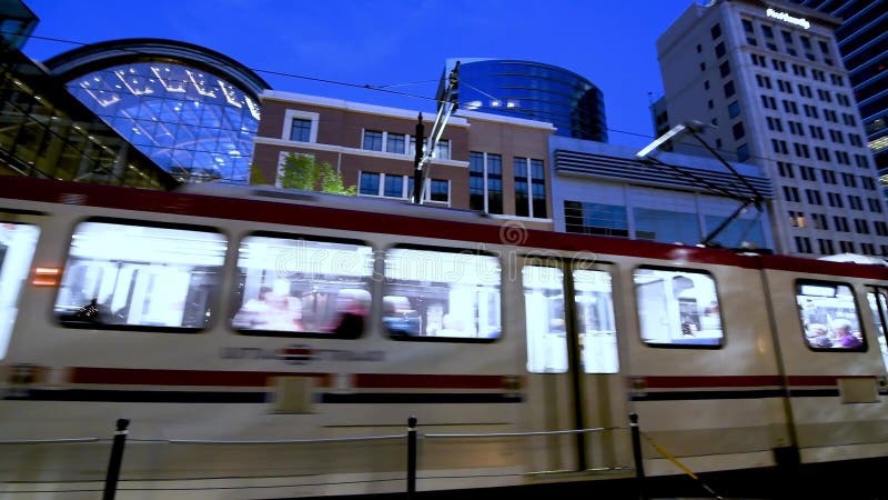 SALT LAKE CITY - JULY 14, 2019: City tram speeds up along Downtown Streets on a beautiful summer night