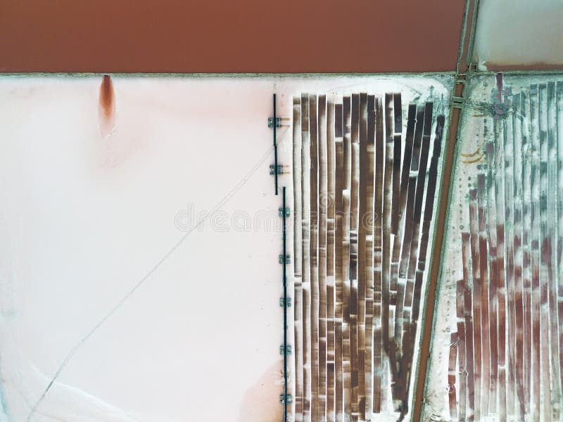 Salt Production line with machines extracting and transporting salt on sunset, aerial view stock photos