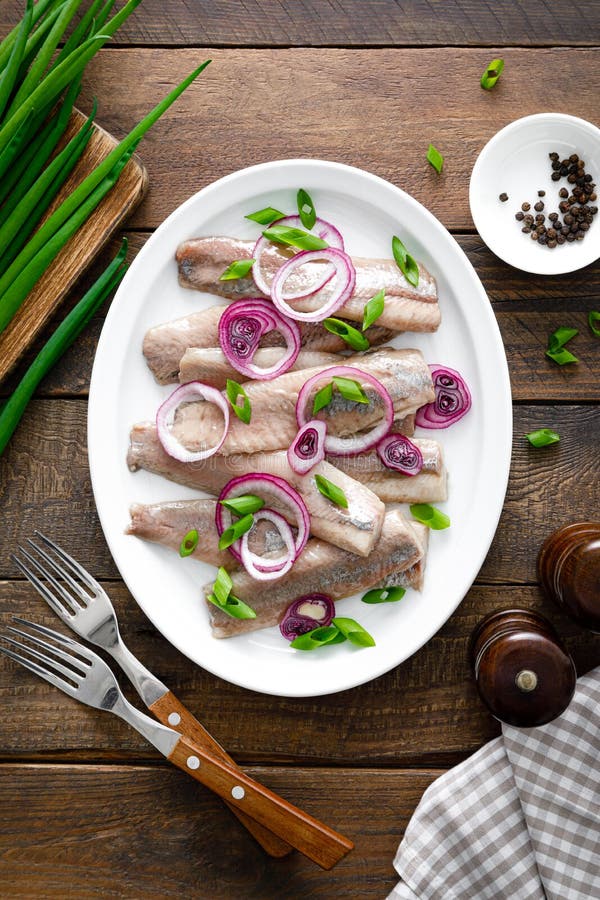 Salted, Marinated Herring Fillet with Onion on Plate Stock Image