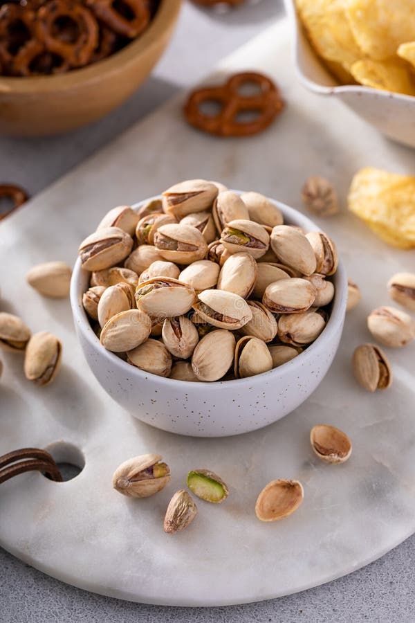 Salted pistachios with other salty snacks usually served with beer. Pistachios served stock images, royalty-free photos and pictures