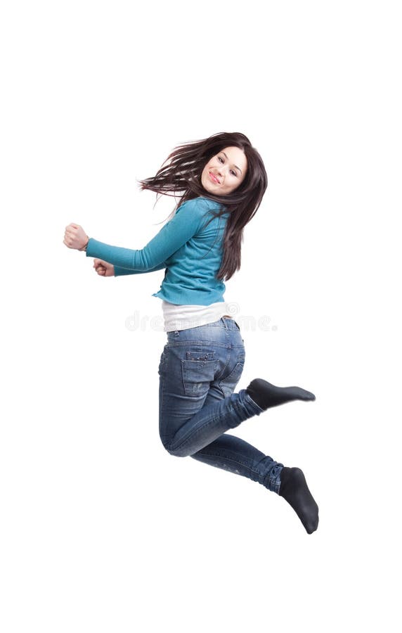 Salto de la mujer joven alegre feliz imagen de archivo