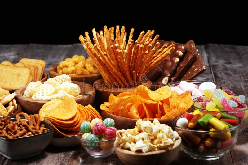 Salty Snacks Pretzels Chips Crackers In Wooden Bowls On Table Stock