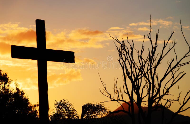 Salvation cross of Christ on hill at sunset