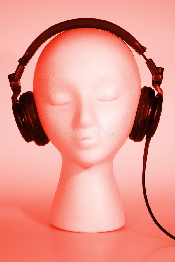 Female mannequin head listening to music with red overlay. Female mannequin head listening to music with red overlay