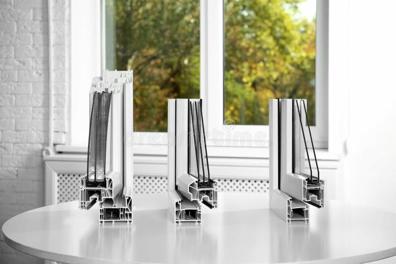 Samples of modern window profiles on table indoors. royalty free stock photo