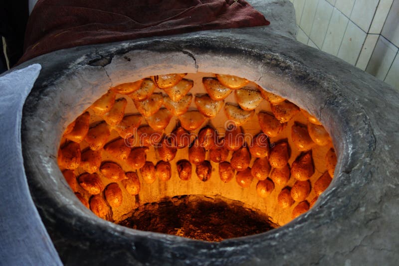 Traditional family bakery and small restaurant with tandoor, clay oven,  where samsa, traditional Uzbek pastry with ground lamb and onion, are baked  an - SuperStock