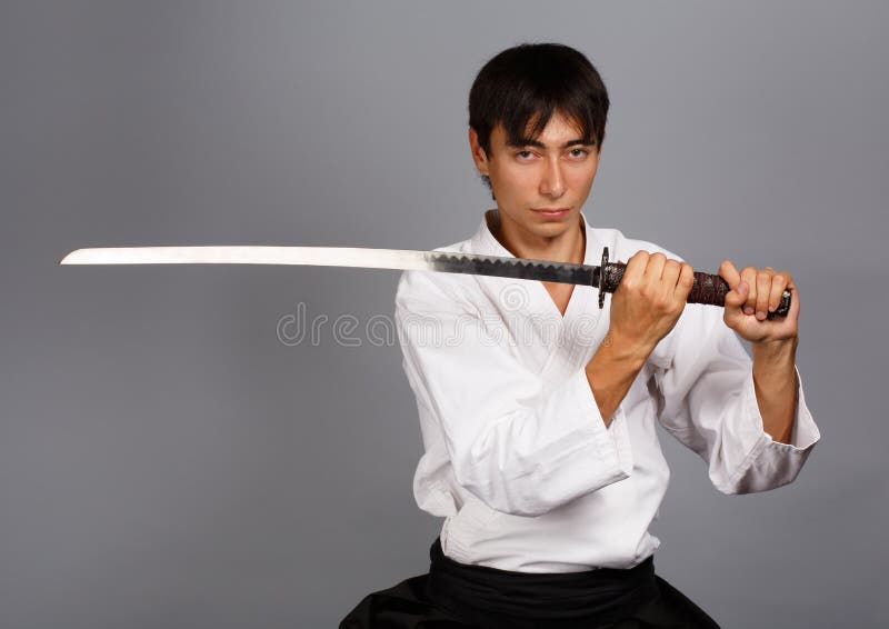 A Man, In A Black Kimono Is Practicing Martial Arts Technique With A Long  Bamboo Fighting Stick. Stock Photo, Picture and Royalty Free Image. Image  91980191.
