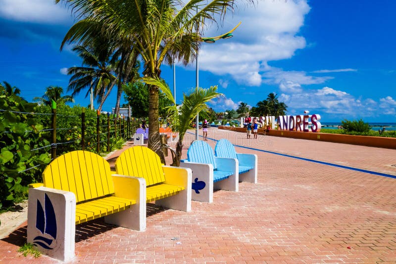 SAN ANDRES, COLOMBIA - OCTOBER 21, 2017: Close up of colorful public chairs, yellow and blue in a boulevar in San Andres