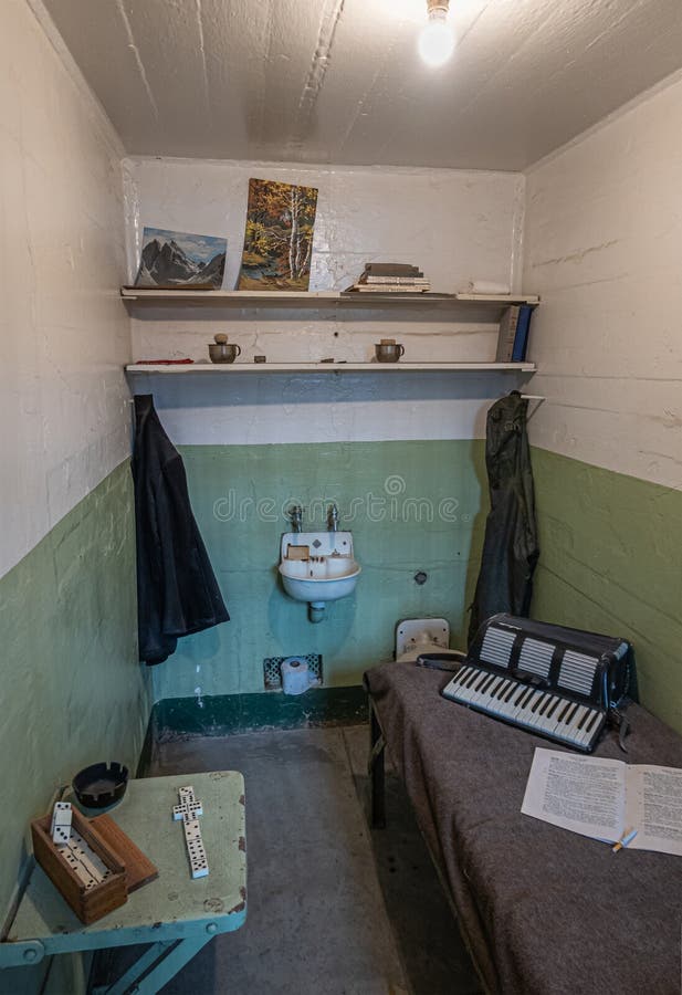 San Francisco, CA, USA - July 12, 2023: Inside historic Alcatraz prison. Donino game set and accordion music instrument in cell. San Francisco, CA, USA - July 12, 2023: Inside historic Alcatraz prison. Donino game set and accordion music instrument in cell