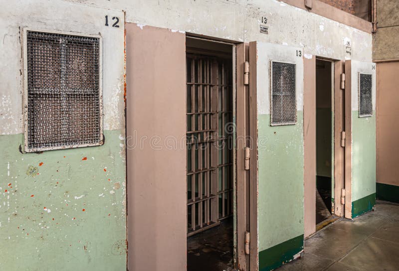 San Francisco, CA, USA - July 12, 2023: Inside historic Alcatraz prison. Solitary cell entrances with double enclosures, metal grid and full doors. San Francisco, CA, USA - July 12, 2023: Inside historic Alcatraz prison. Solitary cell entrances with double enclosures, metal grid and full doors