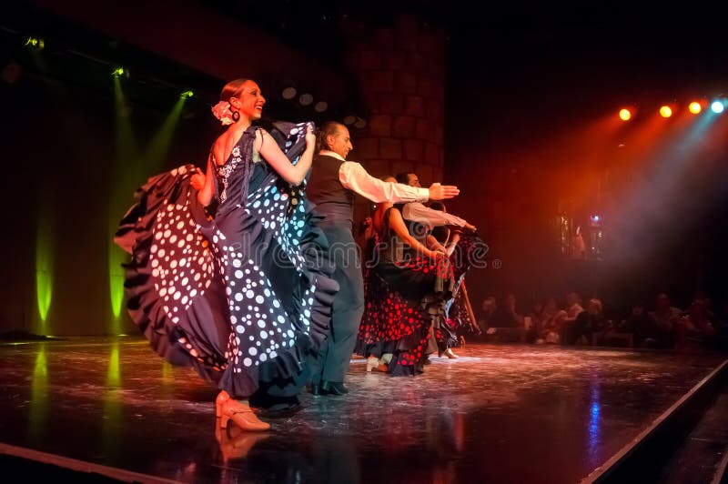 SAN MIGUEL/TENERIFE, SPAIN - March 15, 2014: Beautiful Folk dancers perform the famous Spanish passionate Flamenco dance on the stage of the Castle of San Miguel during a dance show for tourists.