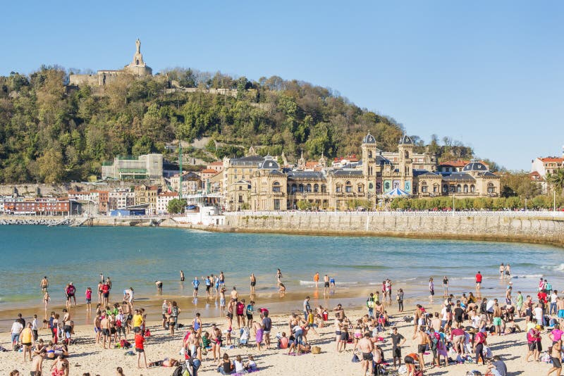 San Sebastian, Donostia, Gipuzkoa, Basque country, Spain-November 08, 2015: people on the beach in San Sebastian. San Sebastian, Donostia, Gipuzkoa, Basque country, Spain-November 08, 2015: people on the beach in San Sebastian.