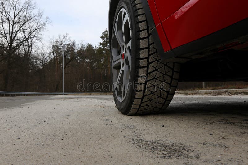 Sand adhered to the surface of a vehicle tyre on the road