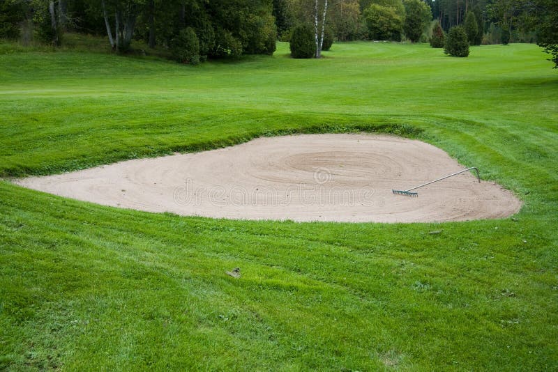 Sand bunker on golf course stock photo. Image of trees 6524578